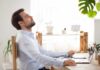 The Science of Silence: How It Rewires Our Brains Man relaxing at desk with eyes closed beside laptop