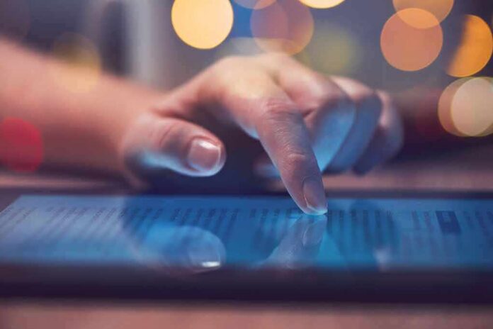 1783890423894-exsgg4-shutterstock-1024804060 Hand tapping a tablet screen