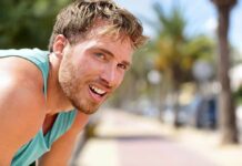 Dopamine Hack: How Exercise Outsmarts Addiction man in athletic tank top resting outdoors