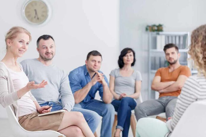 shutterstock_1056944960-1 Support group meeting with six adults seated in a circle