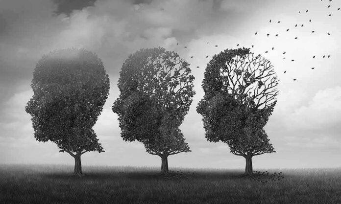 Three trees shaped like human heads losing leaves