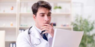 Doctor reviewing a file at a desk