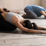 Group of people in child's pose during a yoga class