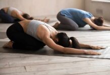 Yoga Rivals Pills For Blood Pressure Group of people in child's pose during a yoga class