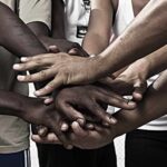 The Evolution of Human Skin Color Group hands stacked together in unity