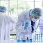 Birth Order Finding Shakes Health Playbook Scientist pipetting blue liquid into test tubes in a laboratory