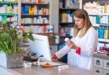 FDA Warning: GLP-1 Microdose Hype Pharmacist checking medication box at computer counter