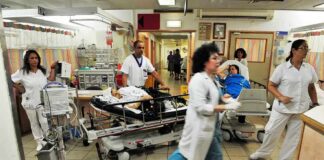 Hospital emergency room with staff moving patients on stretchers