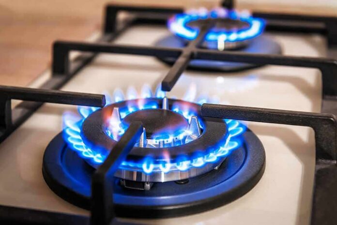 shutterstock_1660250275 Gas stove burner with blue flames