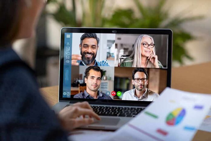 Laptop screen showing a four-person video conference call