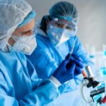 Food Additives Exposed — FDA Finally Moves Scientists in protective gear working with a syringe in a laboratory