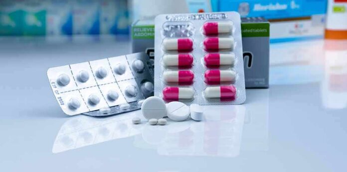 Assorted pills and blister packs on a pharmacy counter