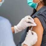 Healthcare worker administers vaccine to patient’s upper arm