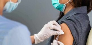Healthcare worker administers vaccine to patient’s upper arm