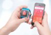 Why Your Sleep Score Is Lying hands holding a smartwatch and a smartphone with health app