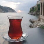 Parkinson’s Risk Drops With This Daily Habit Glass of tea on a saucer by the seaside