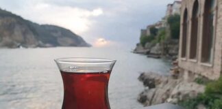 Glass of tea on a saucer by the seaside