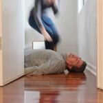 Man lying unconscious on hallway floor