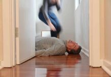 Man lying unconscious on hallway floor