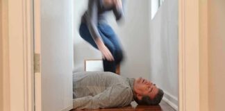 Man lying unconscious on hallway floor