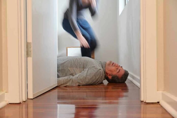 shutterstock_2000141072 Man lying unconscious on hallway floor