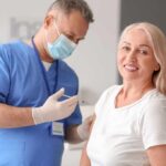 Bad Infection, Lasting Brain Damage? Smiling woman receiving a vaccination from a healthcare worker