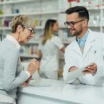 Why Ozempic Quitters Come Crawling Back Pharmacist assists customer at pharmacy counter