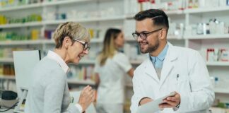 Pharmacist assists customer at pharmacy counter