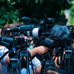 Why Sleep Gets Worse With Age (And What Actually Helps) – Mayo Clinic TV news cameras crowding together at an outdoor event