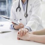 New Study Links Pollution To Arthritis Pain Flares Doctor holding a patient's hands during consultation