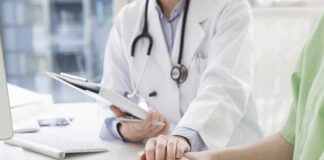 Doctor holding a patient's hands during consultation