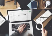Perfectionism’s Lie Found Inside ADHD Brains Person working on a laptop with email inbox open and holding a cup of coffee