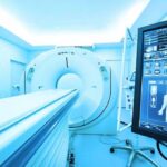 AI That Flags Your Heart Risk Years Early MRI or CT scanner with control monitor in hospital room