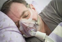 Man sleeping with a CPAP mask on his face