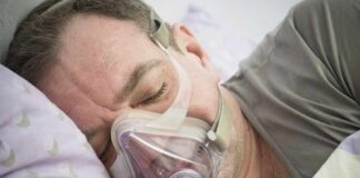 Man sleeping with a CPAP mask on his face