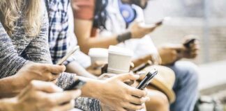 Group of people sitting and using smartphones