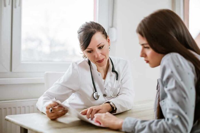 shutterstock_796803439-5 Doctor consulting a patient at a desk