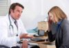 doctor talking to concerned woman in office
