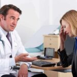 Silent Cancer’s Two-Week Warning Signs doctor talking to concerned woman in office
