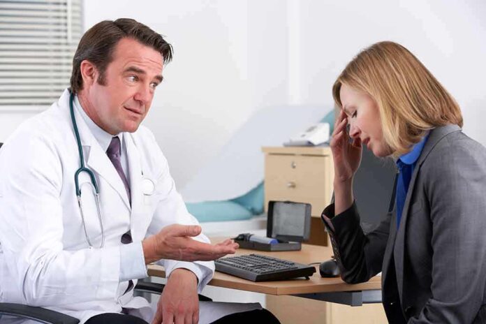 doctor talking to concerned woman in office