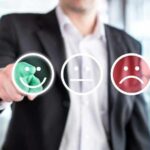 Businessperson selecting a happy face rating icon