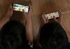 Teen Screen Surge Alarms Researchers Two children playing mobile games side by side on the floor