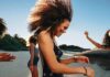 Young woman dancing on a sunny beach