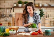 Everyday Foods That Slow DNA Aging Woman preparing a fresh salad in a home kitchen
