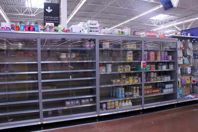 Partially empty store shelves with baby formula and supplies