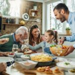 Family gathered around a dining table sharing a meal