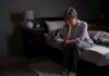 3 A.M. Insomnia? Tips for falling back to sleep Older adult sitting on bed with head in hand