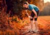 Runner resting on a forest trail in autumn