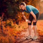 Runner resting on a forest trail in autumn