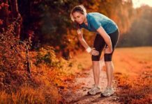 Runner resting on a forest trail in autumn